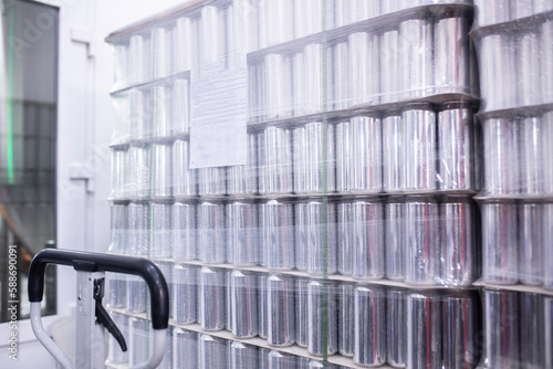 a stack of new aluminium cans on the manufacture, cold drink beverages production. Pallet of metal cans