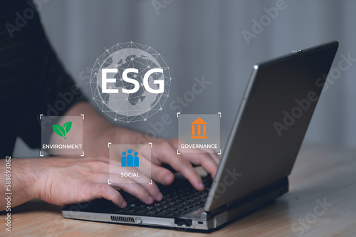 ESG environment social governance investment business concept,Asian man sitting using a computer to analyze ESG,Environment world day