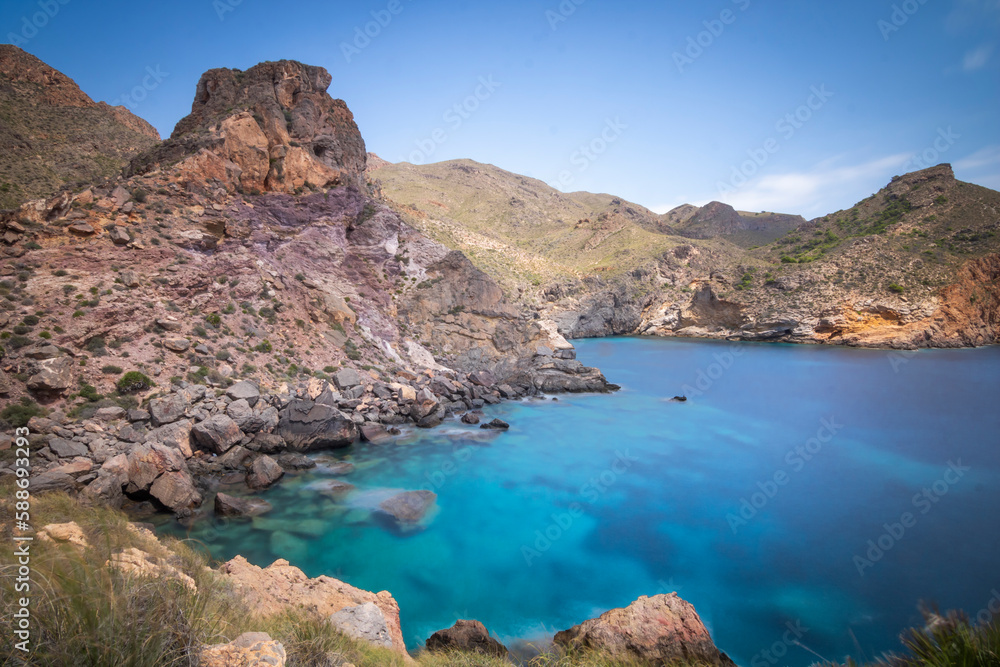 Mountainous environment with cove of blue waters in the background of the coast of Cartagena, Spain, Region of Murcia