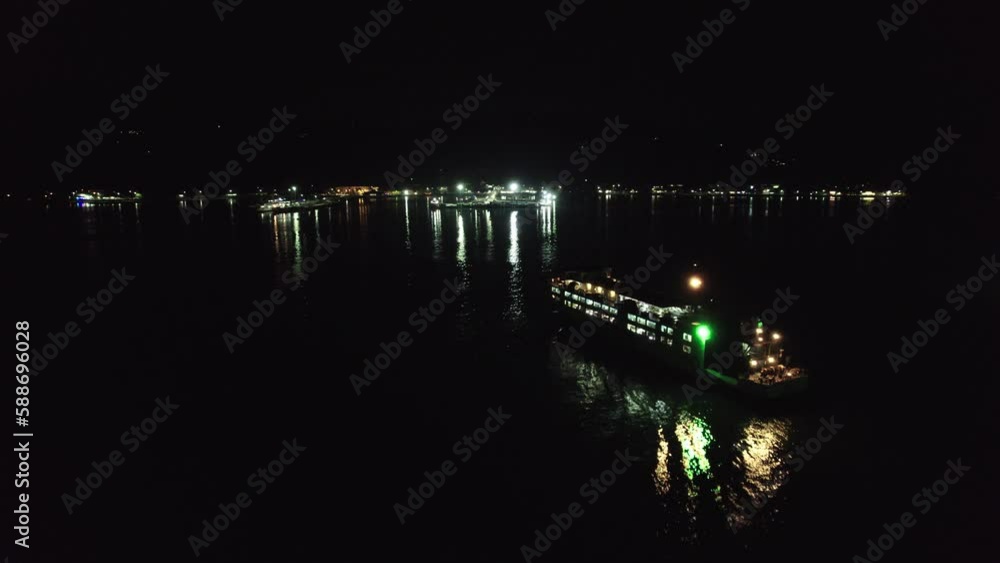 Fly over ferry heading towards harbor, night time, Samui, Thailand Fly over ferry heading towards harbor, night time, Samui, Thailand