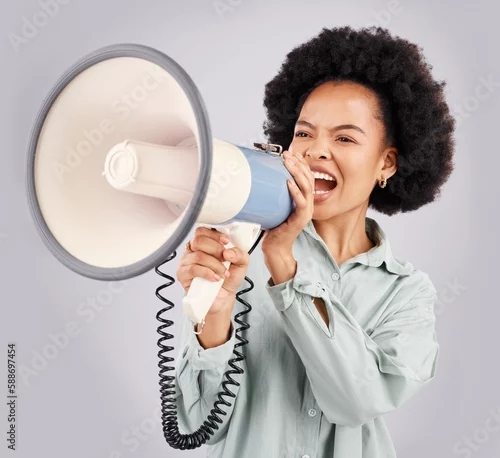 Obraz Megaphone, protest and black woman shouting in studio isolated on white background with voice. Screaming, angry and person with loudspeaker for human rights, change or justice, announcement or speech