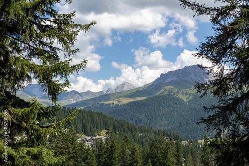 Beautiful shot of mountains and lush trees in Arosa, Switzerland