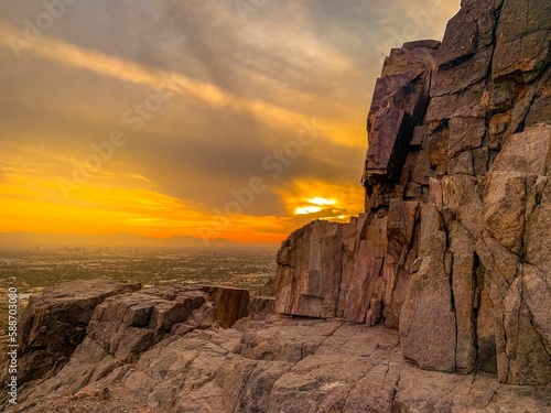 Beautiful view of a town and a rock at a golden sunset