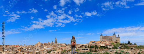 woman tourist standing looking at panorama view of Toledo city landscape in Spain