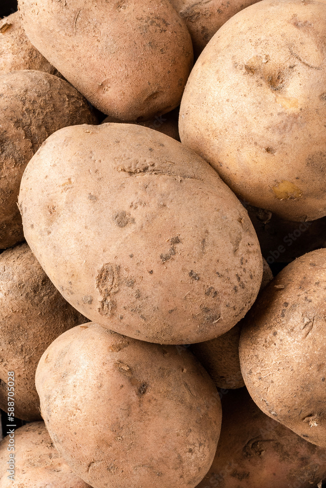 Overhead shot of uncooked potatoes in box on white wooden background. Top view. Close up Overhead shot of uncooked potatoes in box on white wooden background. Top view. Close up