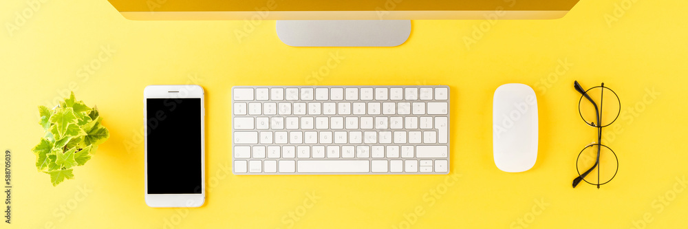 Overhead shot of computer with business accessories on yellow desktop. Modern workspace concept. Flat lay Overhead shot of computer with business accessories on yellow desktop. Modern workspace concept. Flat lay