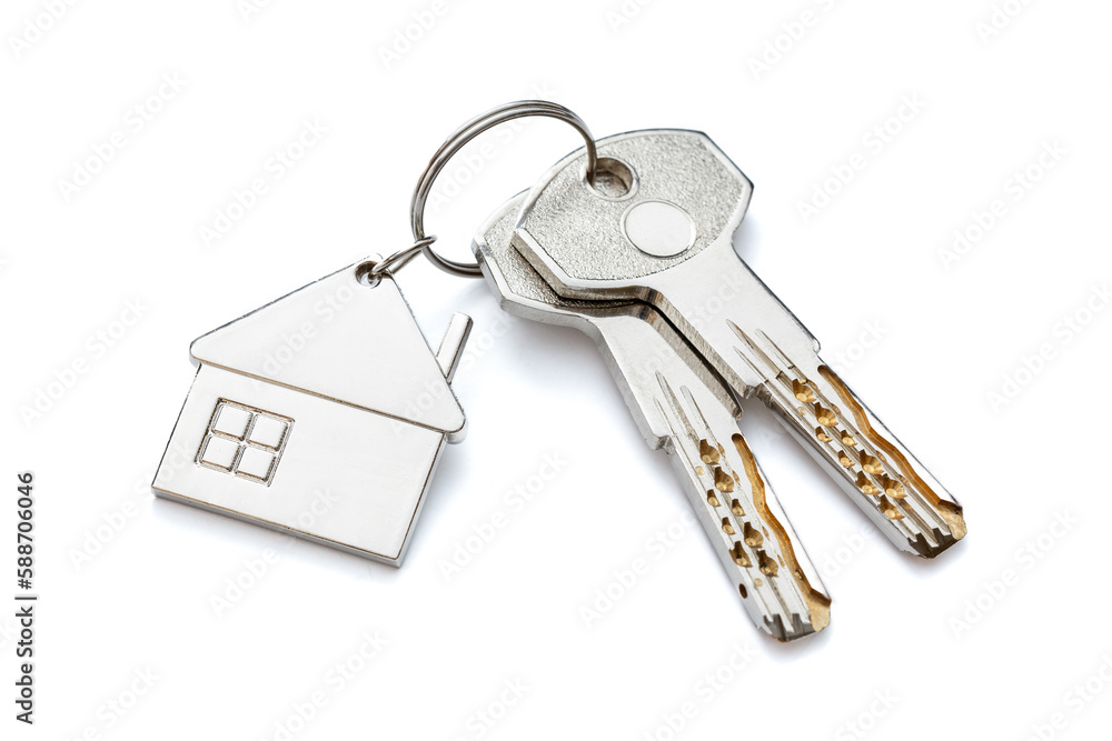 Keychain in the form of a house with two keys. Close-up. Highlighted on a white background. Keychain in the form of a house with two keys. Close-up. Highlighted on a white background.