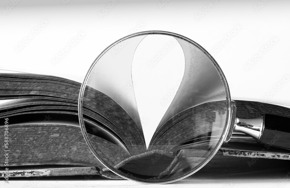Open book, close up with magnifying glass,reading, education, knowledge