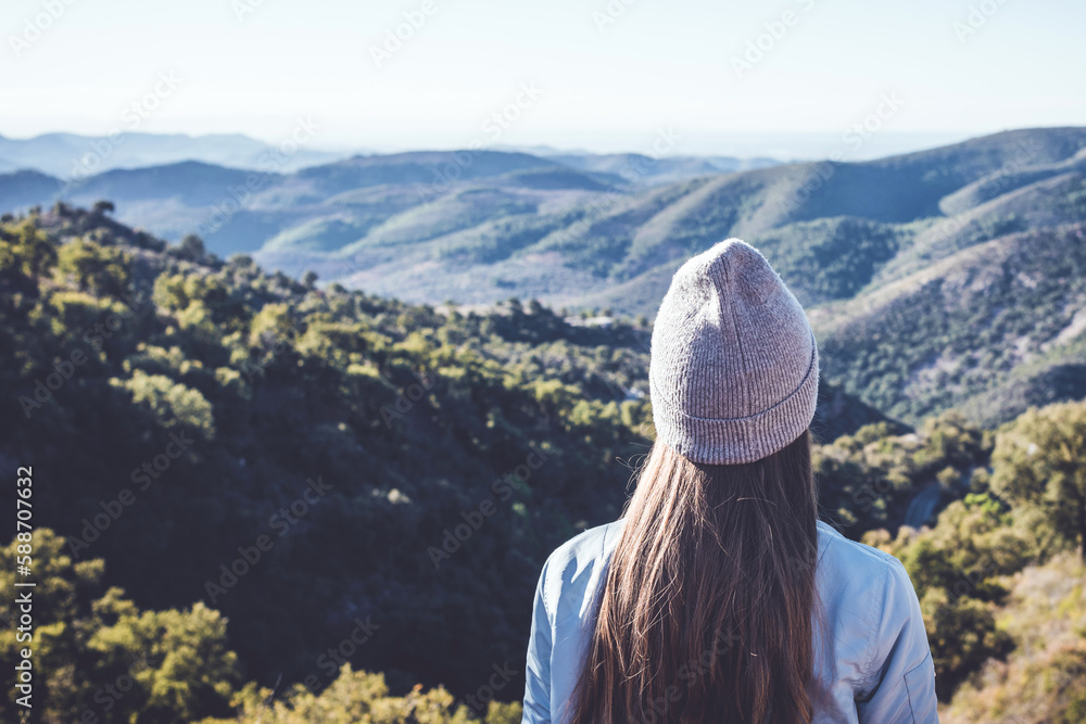 Woman in winter hat looking at mountains