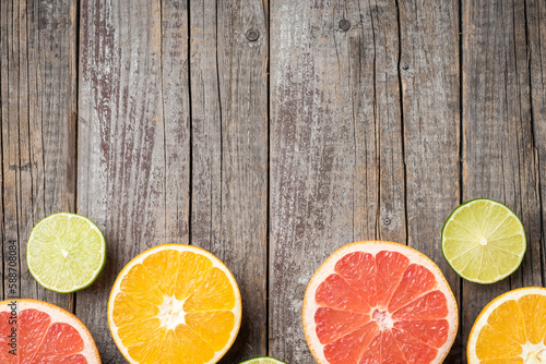Fototapeta Naklejka Na Ścianę i Meble -  Colorful fruits background with orange, grapefruit and lime halves. Top view