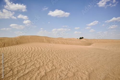 Scenic view of large desert landscape under blue cloudy sky