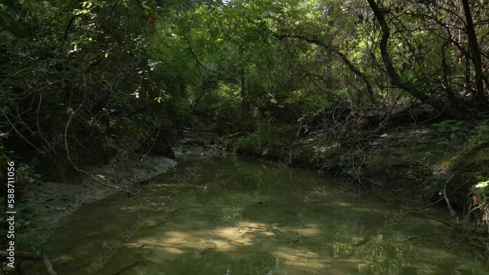 Beautiful view of woods in Lost Creek in Allen TX with river, rocks and light falling from trees Beautiful view of woods in Lost Creek in Allen TX with river, rocks and light falling from trees