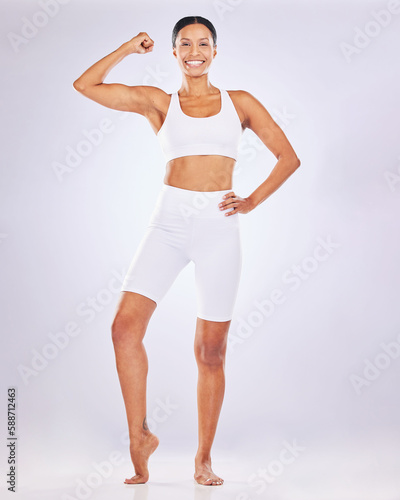 Health, muscle flex and woman for body wellness, healthy diet and exercise on studio background. Beauty, fitness and portrait of happy girl flexing in underwear for workout, strength and weight loss