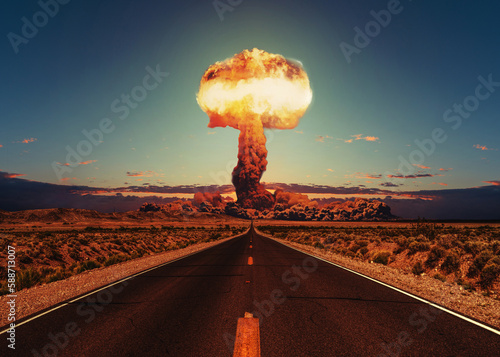 Asphalt road goes to a nuclear explosion. Terrible atomic explosion of a nuclear bomb with a mushroom cloud of radioactive dust. Hydrogen bomb test. Nuclear catastrophe. Way to nuclear war photo