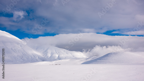 Winter landscape, valley and hills covered with snow on bright sunny day © Maresol