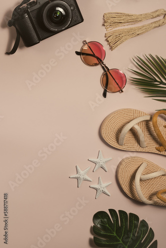 passport, sunglasses, straw flip flop, on pink background, flat lay, top view.