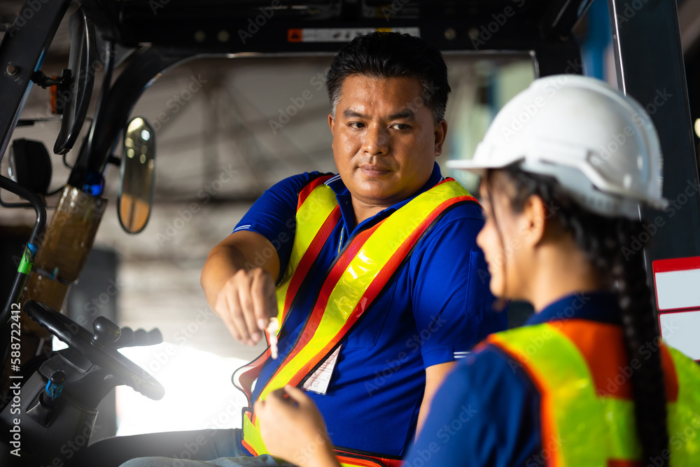 Asian man driver gave the key to his colleague. Warehouse staff worker by goods shelf working in large warehouse factory Asian man driver gave the key to his colleague. Warehouse staff worker by goods shelf working in large warehouse factory