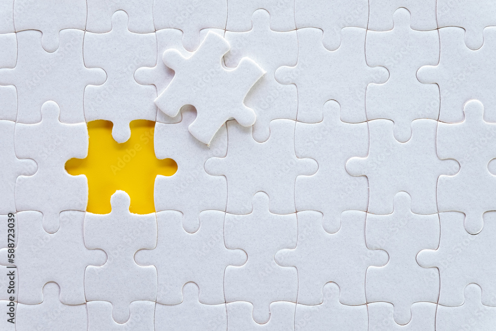 Top view of White jigsaw puzzle texture over yellow background. Top view of White jigsaw puzzle texture over yellow background.