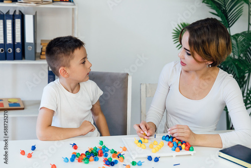educational games for children a child psychologist is engaged with a boy in the office