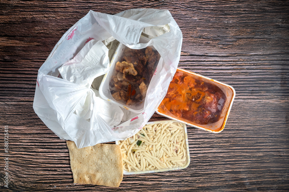 Chinese takeaway food selection in plastic bag. Bami, babi pangang ...