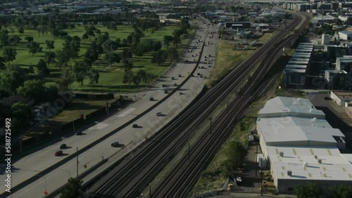 i25 downtown Denver traffic to downtown city reveal pan up aerial drone summer blue green photo