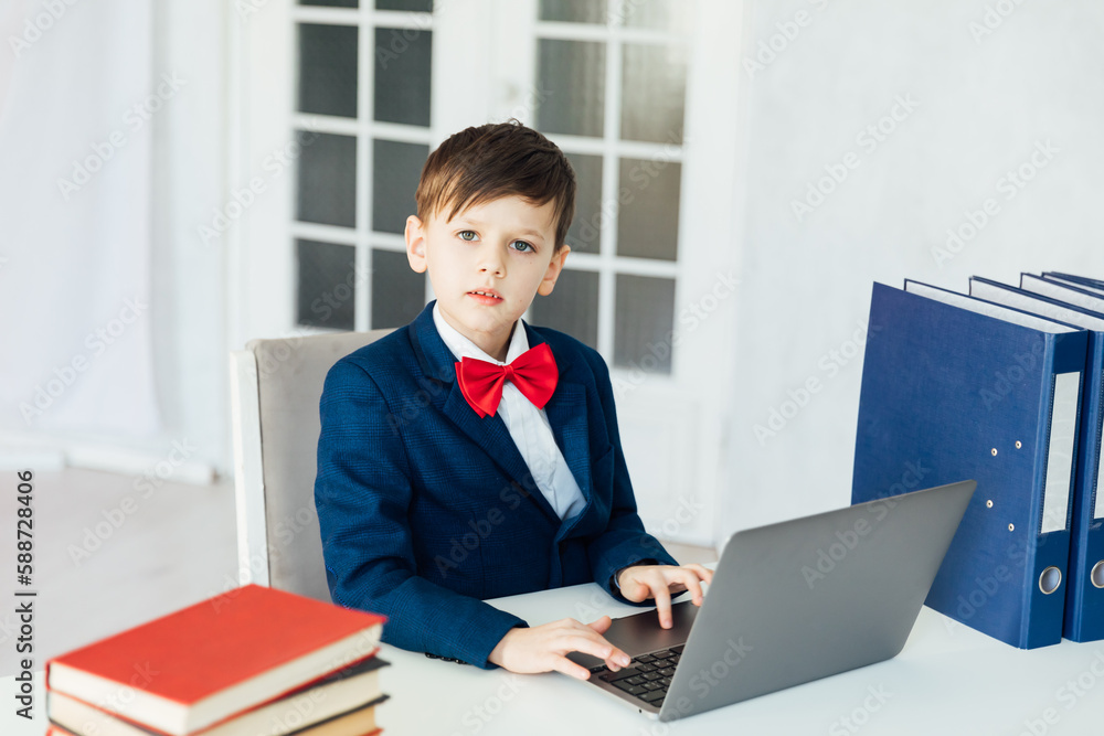 student sitting in the classroom at a laptop with books in the office education online programming student sitting in the classroom at a laptop with books in the office education online programming