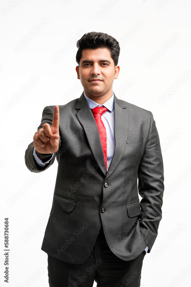 Young indian businessman pointing in front off with finger. Young indian businessman pointing in front off with finger.