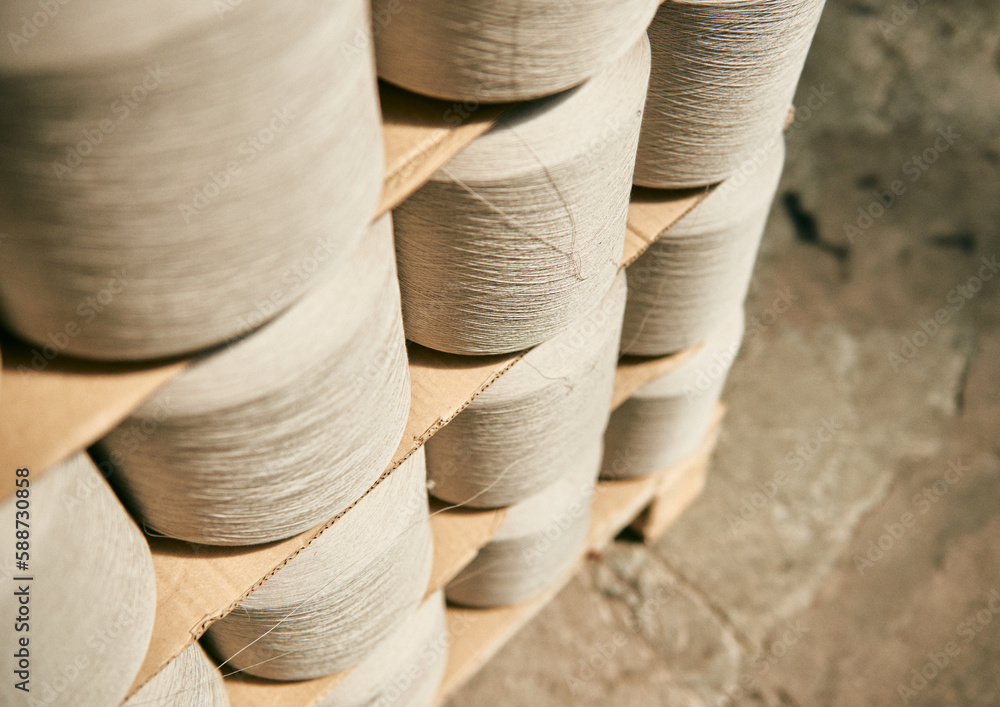 Raw spindles of industrial cotton in a weaving factory, hand weaving cotton for the fashion and