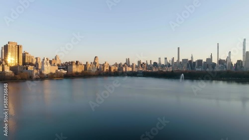 Jacqueline Kennedy Onassis Reservoir, the Central park and sunlit buildings on the Upper West Side of New York, USA - aerial view