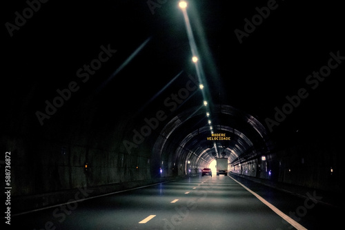Luminous sign with message for drivers, moderate speed, inside the tunnel. Tunel do Marão is a road tunnel located in Portugal that connects Amarante to Vila Real, crossing the Serra do Marão. photo