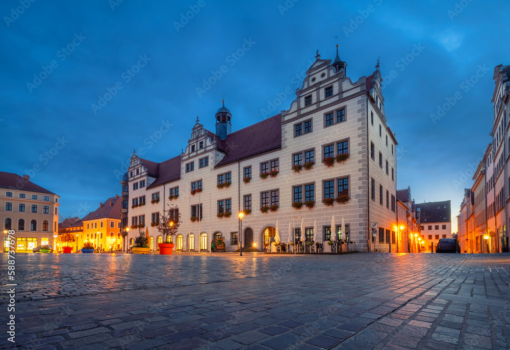Torgau, Germany. View of the building of historic Town Hall at dusk