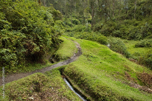 Water canal under the waterfall Cascada de Peguche in the northeast of Otavalo, Ecuador, South America
 photo