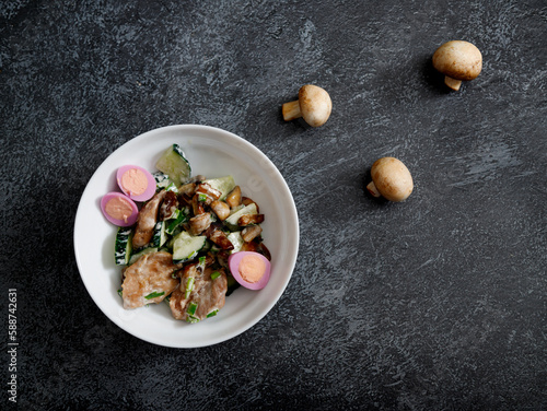 warm salad with chicken breast, mushrooms, egg and fresh arugula.