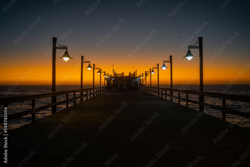Beautiful Romantic Orange Sunset at Wooden Pier at the Sea