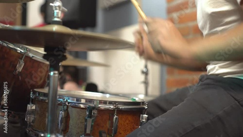 Close-up of drummer with full drum set playing song with band, no face photo