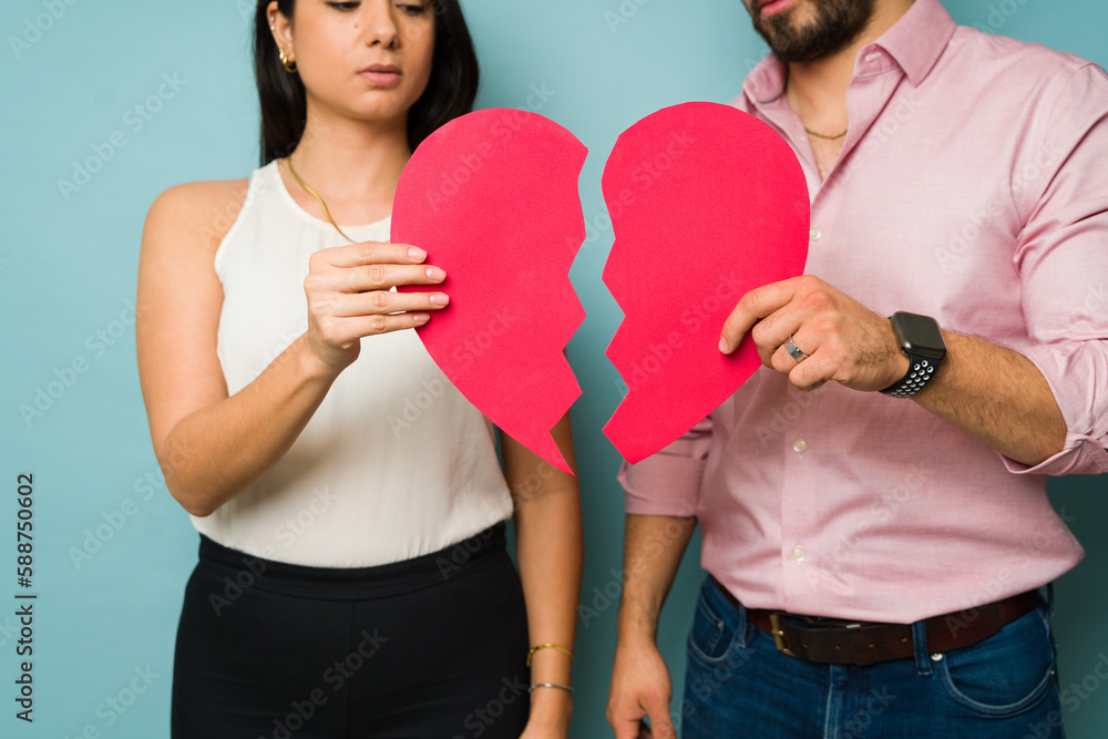 Sad couple breaking up and suffering from a broken heart Sad couple breaking up and suffering from a broken heart