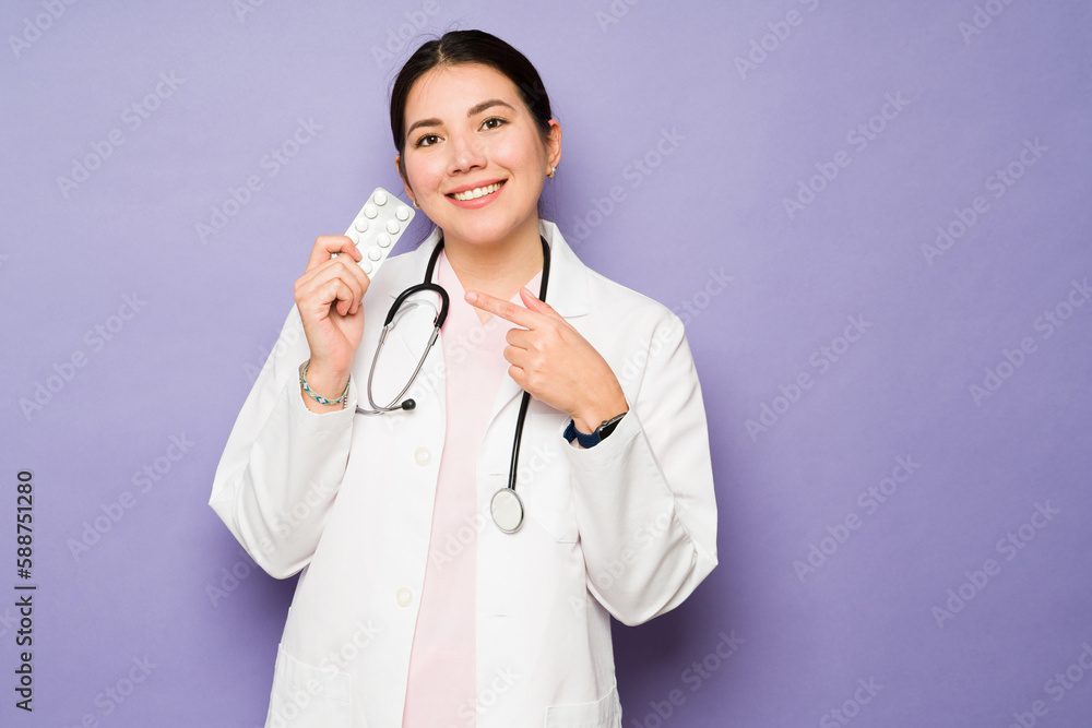 Happy female doctor showing prescription pills Happy female doctor showing prescription pills