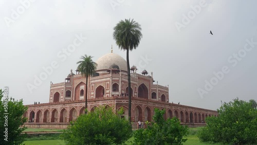 Panoramic view of Humayun Tomb, mosque with tourists and green public park around in the daylight in New Delhi in India photo