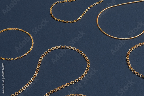 Golden chains collection. Jewellery set of necklaces on dark background.
