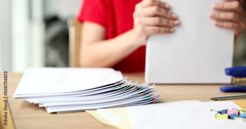 Business woman works with stacks of paper files to search and check unfinished document. Paperwork in office with busy desk Business woman works with stacks of paper files to search and check unfinished document. Paperwork in office with busy desk