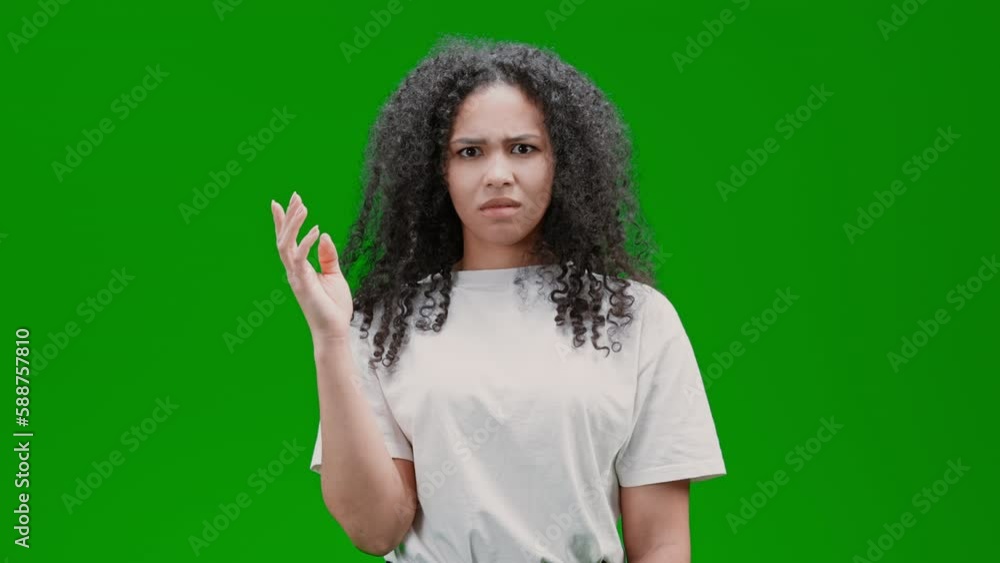 woman with curly long hair dressed white shirt expressing hesitation feels puzzled embarrassed smiling Isolated on Green Screen woman with curly long hair dressed white shirt expressing hesitation feels puzzled embarrassed smiling Isolated on Green Screen