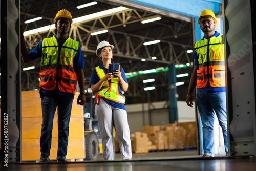 Group of warehouse asian indian workers wearing safety hardhats helmet inspection in container at warehouse. E-Commerce Goods at Logistics Warehouse factory.warehouse interior with shelves, pallets 