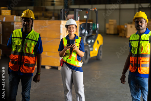 Group of warehouse asian indian workers wearing safety hardhats helmet inspection in container at warehouse. E-Commerce Goods at Logistics Warehouse factory.warehouse interior with shelves, pallets 