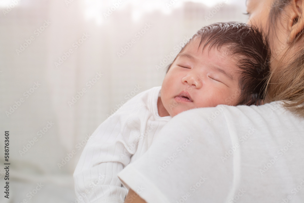 happy loving family. mother playing with her baby hugging in the bedroom , portrait of asian mother playing with newborn baby, health care family love together. asian girl lifestyle.. happy loving family. mother playing with her baby hugging in the bedroom , portrait of asian mother playing with newborn baby, health care family love together. asian girl lifestyle..