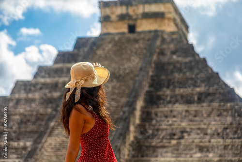 Tourist observing the old pyramid and temple of the castle of the Mayan architecture known as Chichen Itza, it is a ruins belonging to this ancient pre-columbian civilization and is part of humanity.