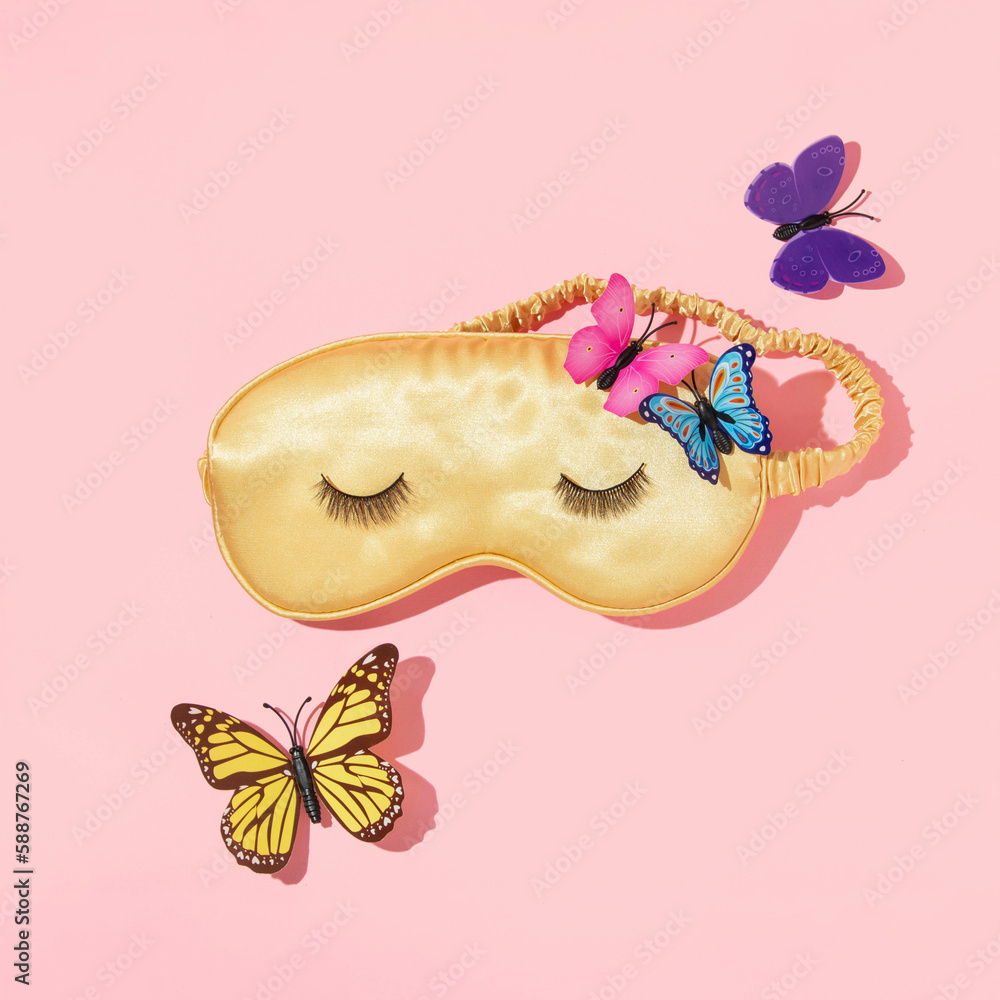 Spring creative layout with yellow sleep mask and colorful butterflies
