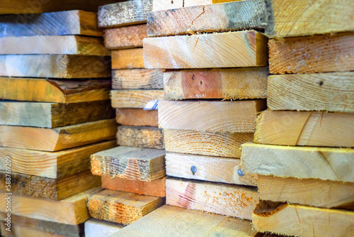 Wooden boards are stacked in a sawmill or carpentry shop. Drying and marketing of wood..
