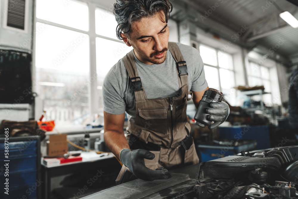 Mechanic examining car in auto car repair service center Mechanic examining car in auto car repair service center