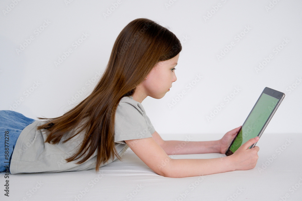 Digital tablet with empty screen. Young girl holding tablet in her hands with blank green screen Digital tablet with empty screen. Young girl holding tablet in her hands with blank green screen