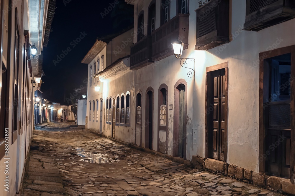 Paraty, Brazil. Street in historic downtown at night. Colonial period houses and stone street lit with old light fixtures. Unesco World Heritage.
